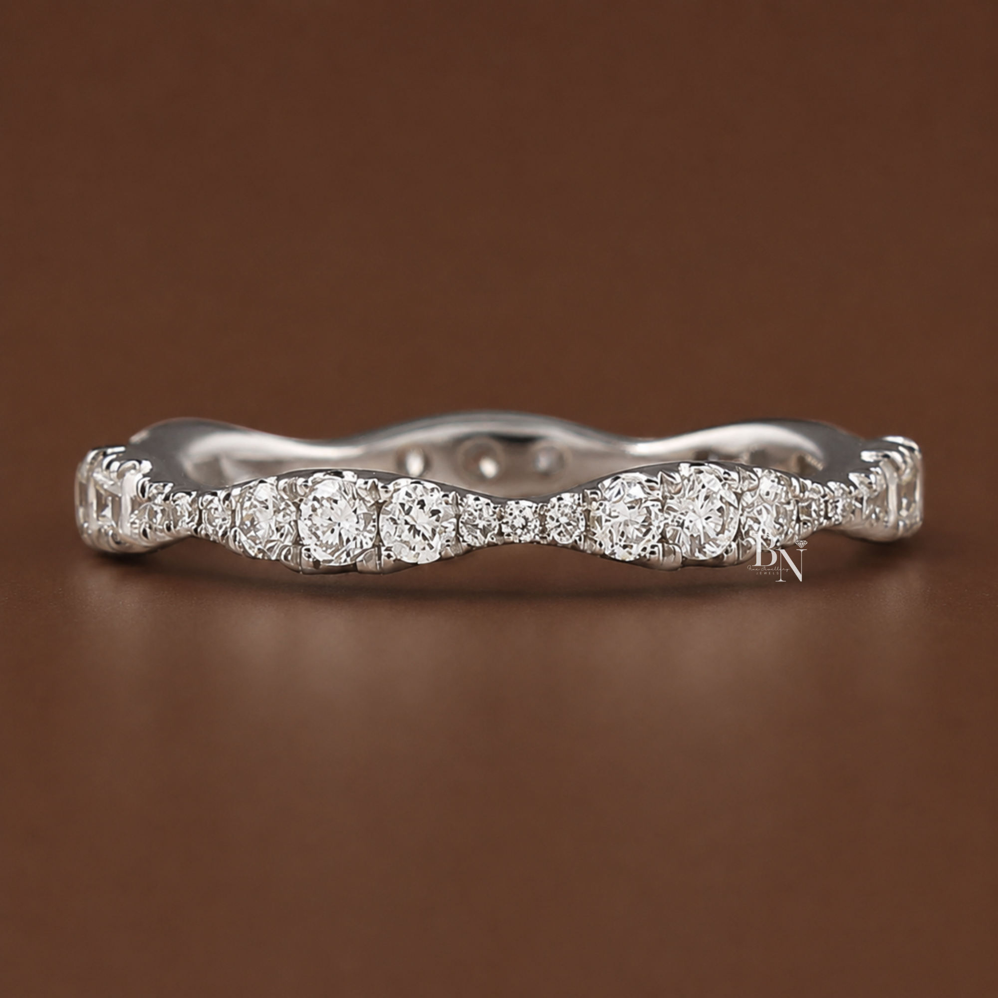 0.55 carat total weight round lab diamond full eternity band in 14K white gold. Features a unique wavy design with pave set stones in graduating sizes measuring 2.40mm at its widest. Perfect luxury fine jewelry bridal stack or anniversary gift.