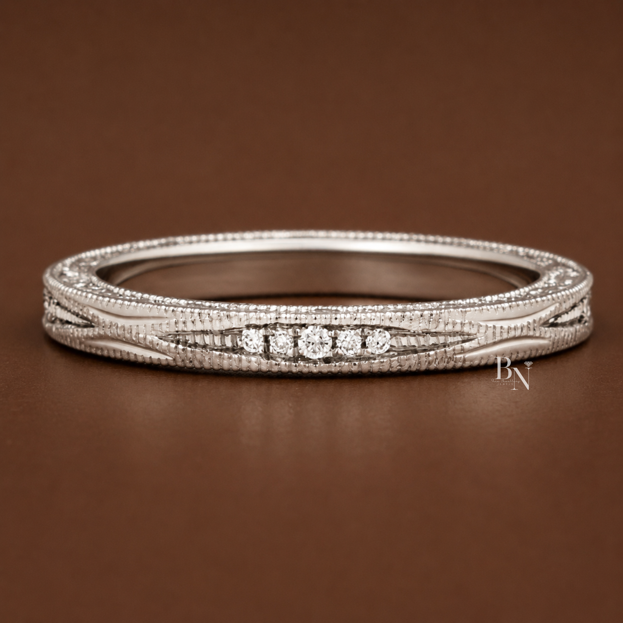 Vintage inspired 14k gold wedding band featuring 0.10ctw lab grown diamonds, delicate scroll engraving, and milgrain edges, perfect for bridal stacks.
