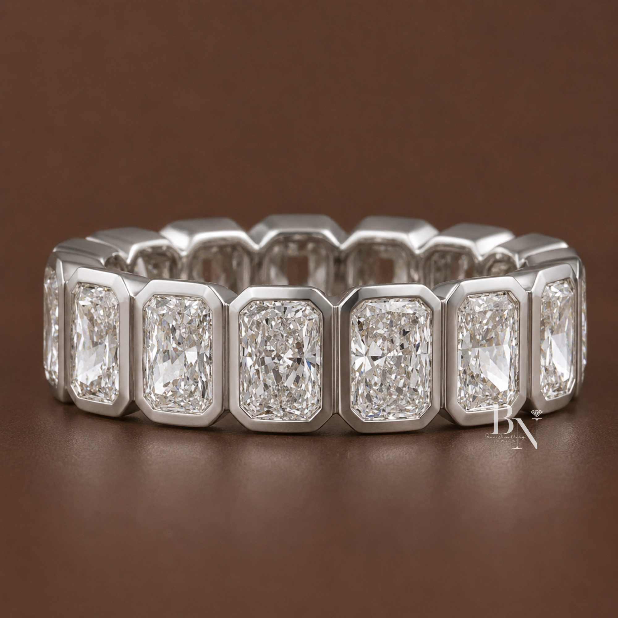 Radiant cut lab diamond full eternity band featuring a modern bezel setting in 14K solid gold. Showcasing 4 total carats of perfectly matched diamonds, this luxurious 5.5mm wide bridal and anniversary ring is displayed on-hand and isolated.
