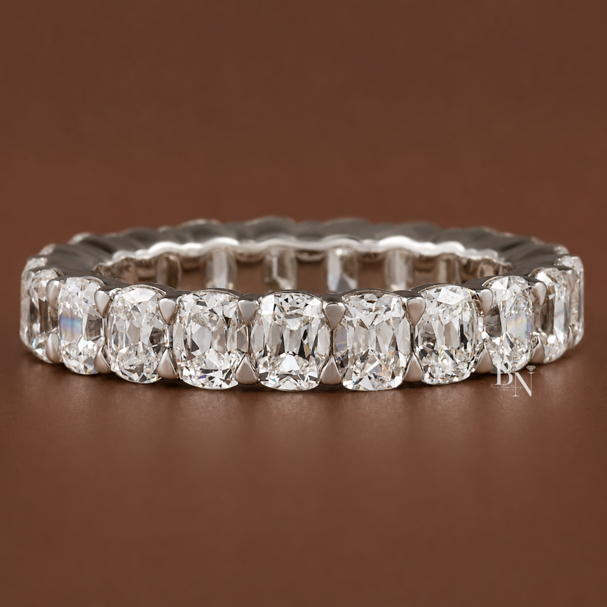 Antique cushion cut lab diamond full eternity band in a shared prong closed basket setting. Showcasing 3.20 total carats in 14K solid gold on a 3.7mm band, this luxury bridal and anniversary ring is displayed on-hand and in multiple gold tones.