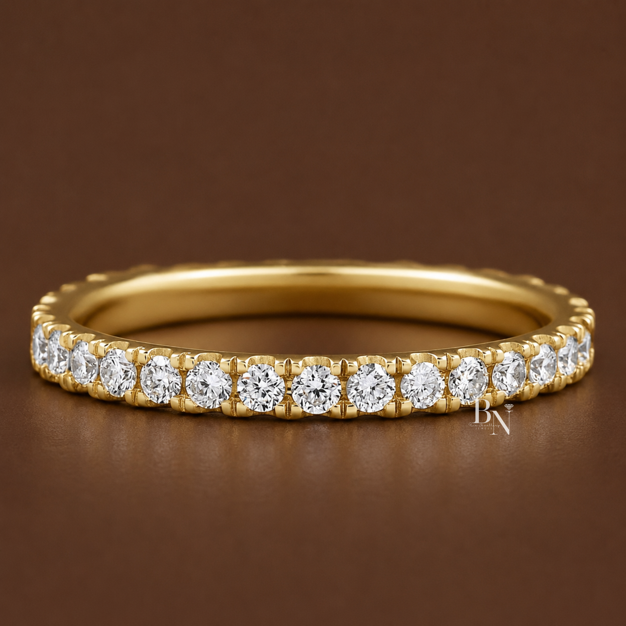 Round brilliant cut lab diamond full eternity band in a classic pave setting. Showcasing 0.60 total carats on a delicate 2.2mm 14K gold band, this luxury bridal stacking ring is displayed on hand and isolated in white, yellow, and rose gold.