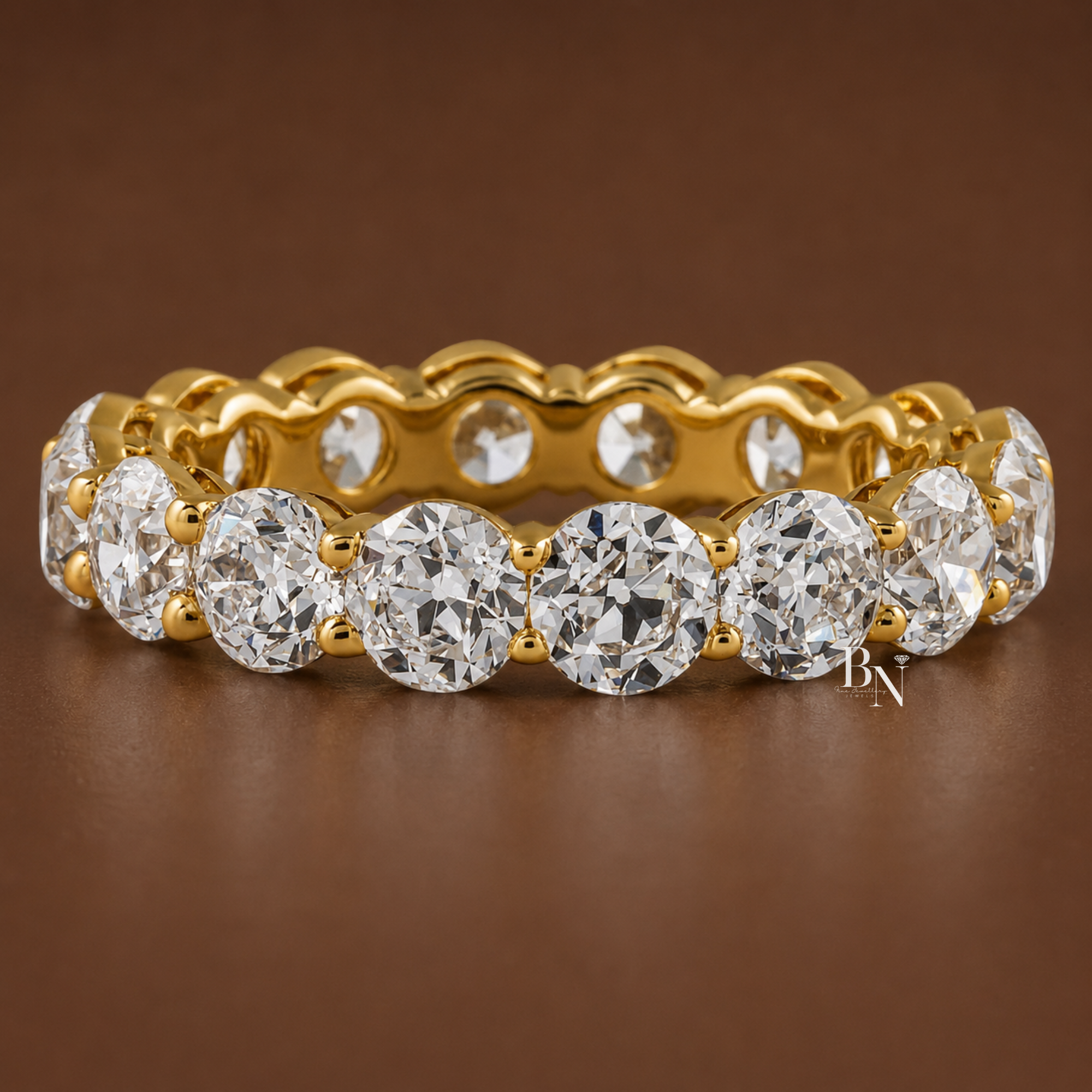 Old European cut lab diamond full eternity band in an open airline wire basket setting. Showcasing 4.60 total carats on a 4.6mm solid gold band, this luxury vintage inspired bridal stacking ring is displayed on hand and in multiple gold tones.