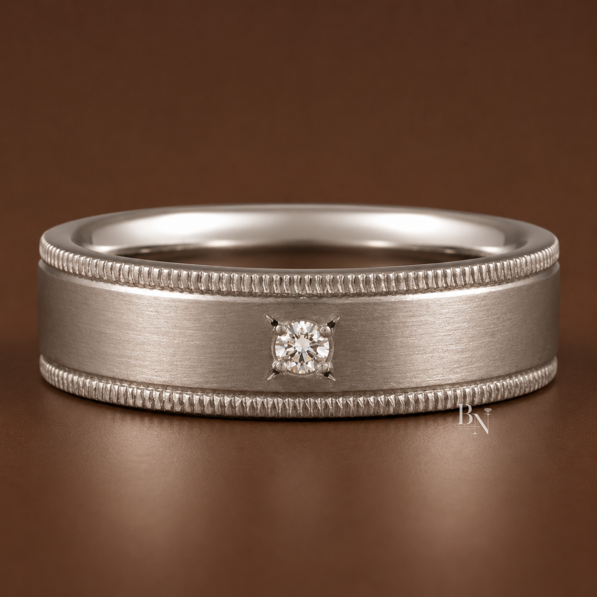 A 5.5mm platinum band with a sophisticated satin finish and delicate milgrain edges, featuring a single, round-cut lab-grown diamond star setting, perfect for modern bridal stacks.