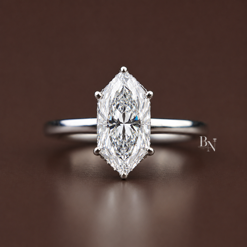 A sophisticated 1.5 carat Dutch marquise cut lab grown diamond solitaire engagement ring featuring a sleek, modern bezel setting on a delicate, hand-carved gold band with intricate vintage filigree side detailing.