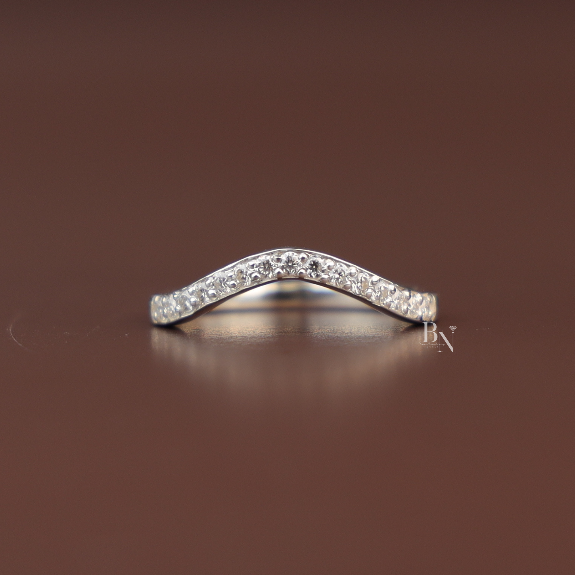 V-curved pavé-set lab diamond wedding band in white gold, contoured nesting ring designed to fit engagement rings, delicate bridal stacking band.