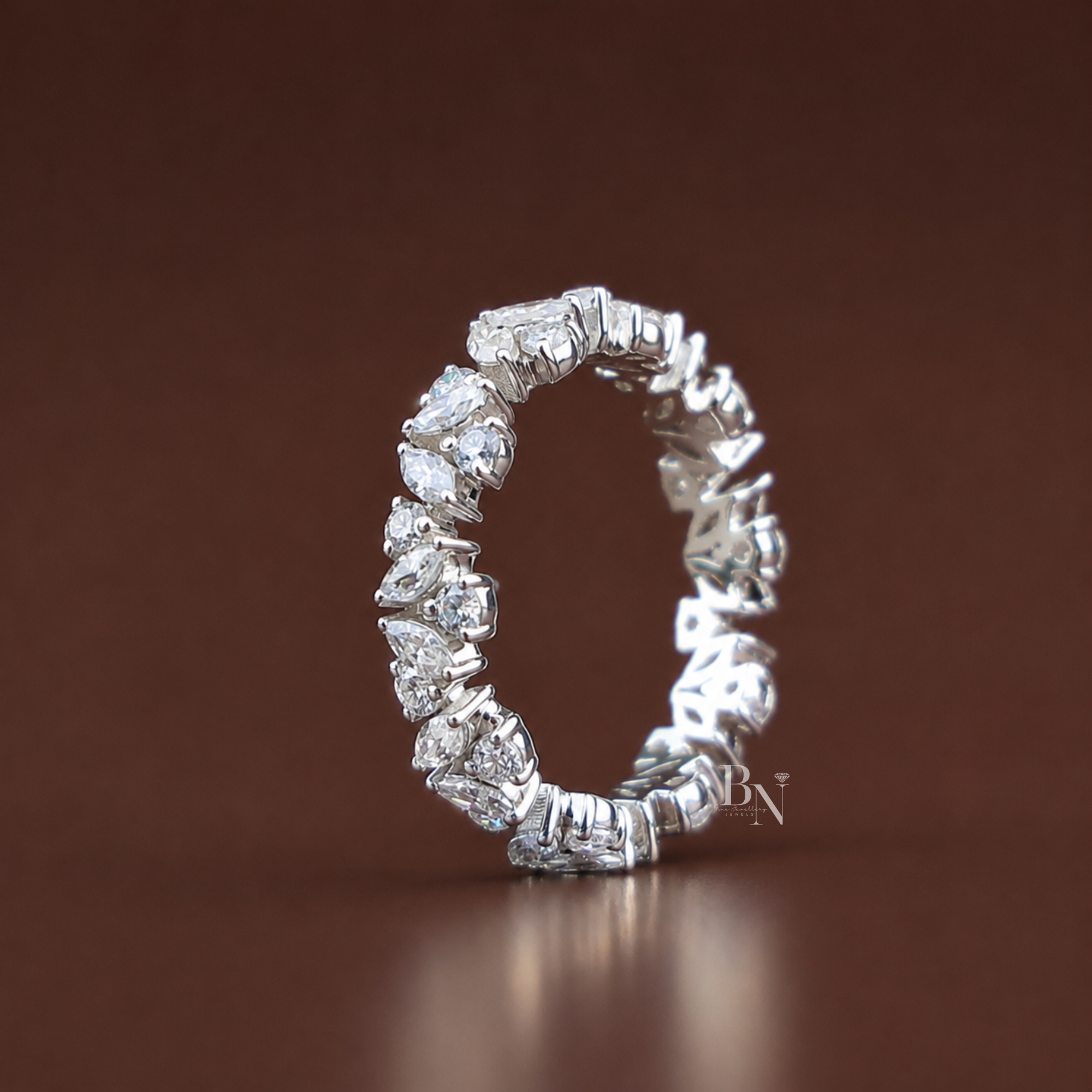Eternity band featuring alternating marquise and round cut lab diamonds in a white gold setting, delicate floral inspired wedding stackable ring.