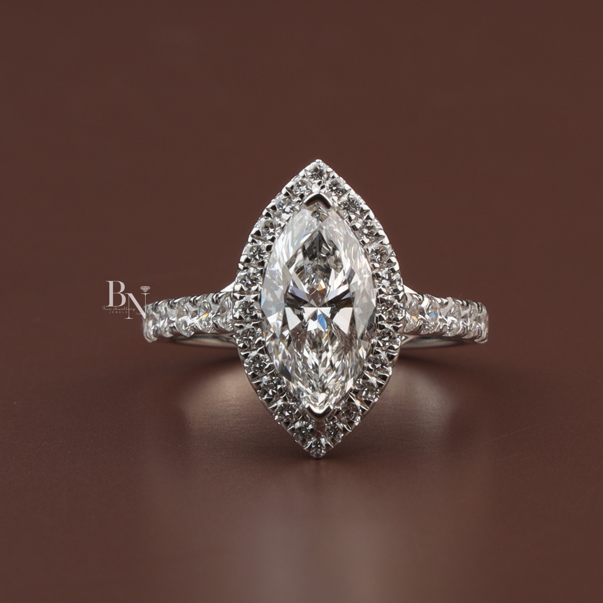 Marquise cut lab diamond engagement ring with halo and pavé band in 10k white gold, featuring intricate detailing and a 1.50 carat center stone appearance.
