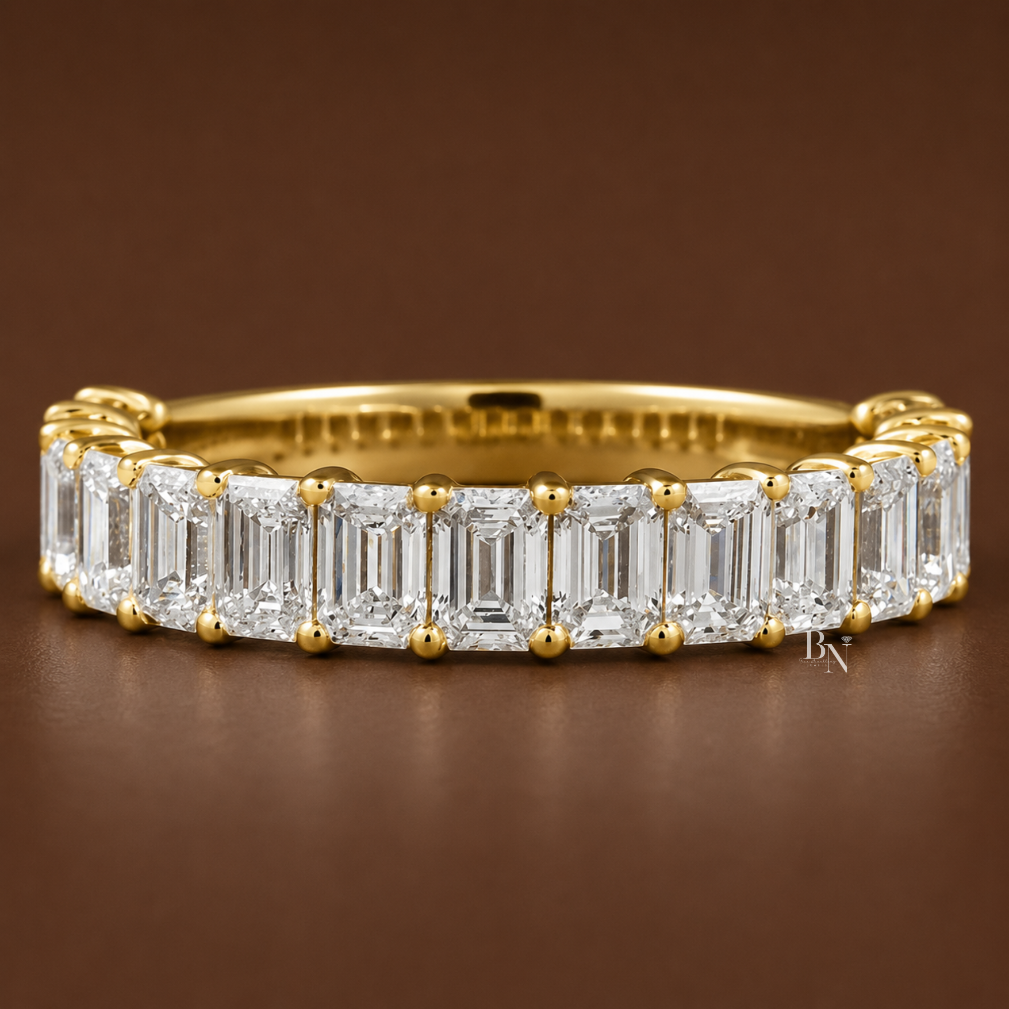 Close-up on-hand view of a white metal 4.1mm wedding band featuring 2.08 carats of vertical emerald-cut lab diamonds set in a 3/4 eternity style.