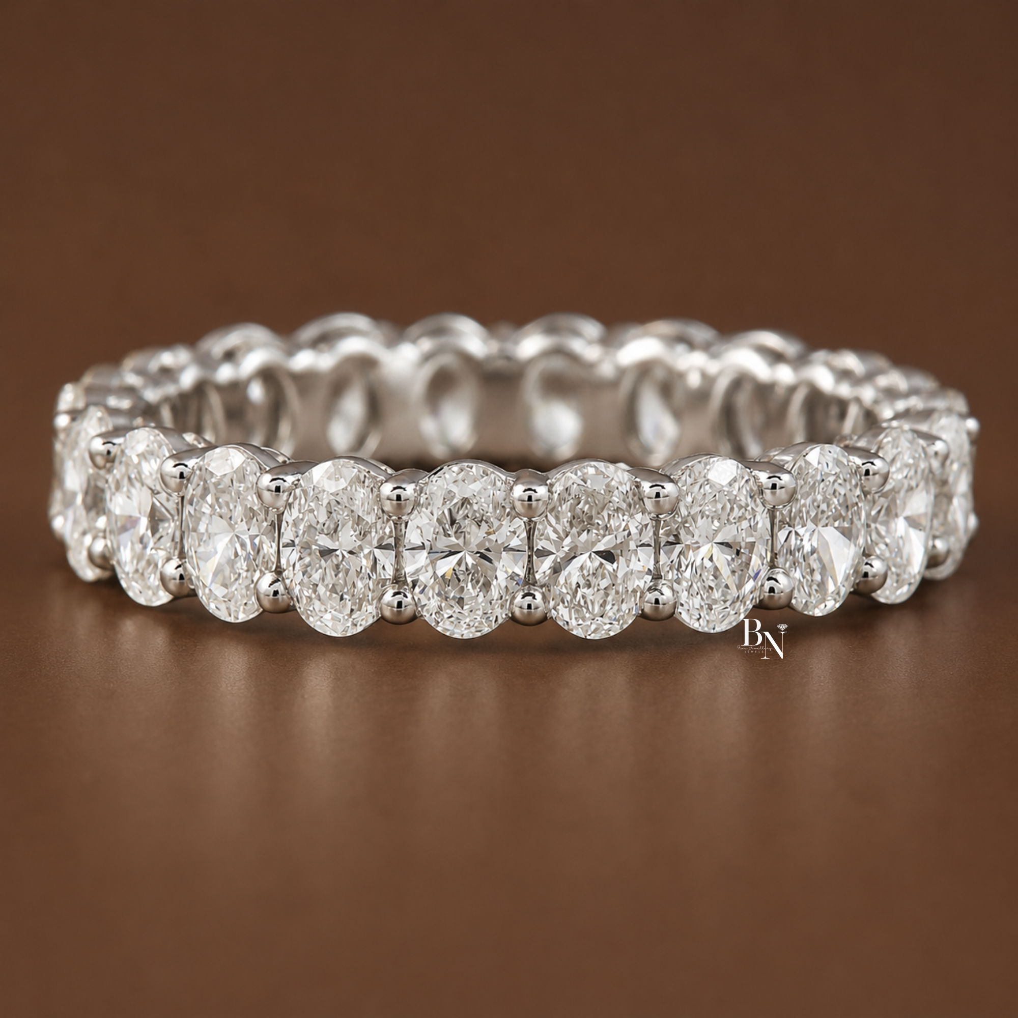 2.20 carat total weight oval lab diamond full eternity band in a solid gold open airline basket setting. Measuring 3.9mm wide, this perfectly matched fine jewelry bridal stacking ring showcases exceptional brilliance and luxury craftsmanship.