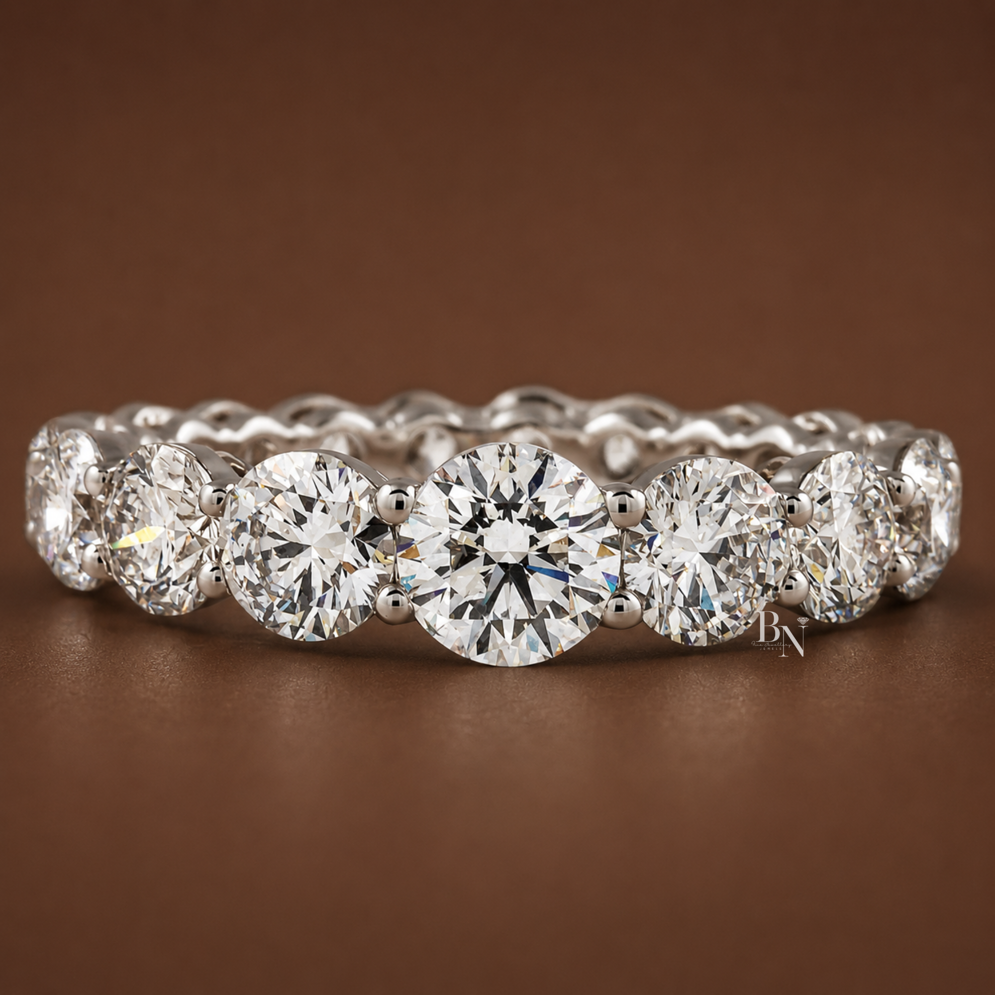 Front view of a 14K yellow gold eternity band featuring round lab diamonds that elegantly taper in size from largest in the center to smallest at the edges.