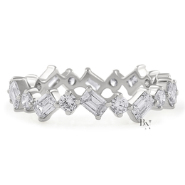 Angled view of a 14K yellow gold eternity band featuring a zig-zag pattern of alternating emerald-cut and round brilliant lab-grown diamonds.