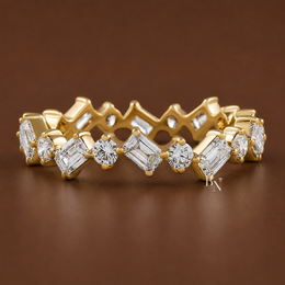 Angled view of a 14K yellow gold eternity band featuring a zig-zag pattern of alternating emerald-cut and round brilliant lab-grown diamonds.