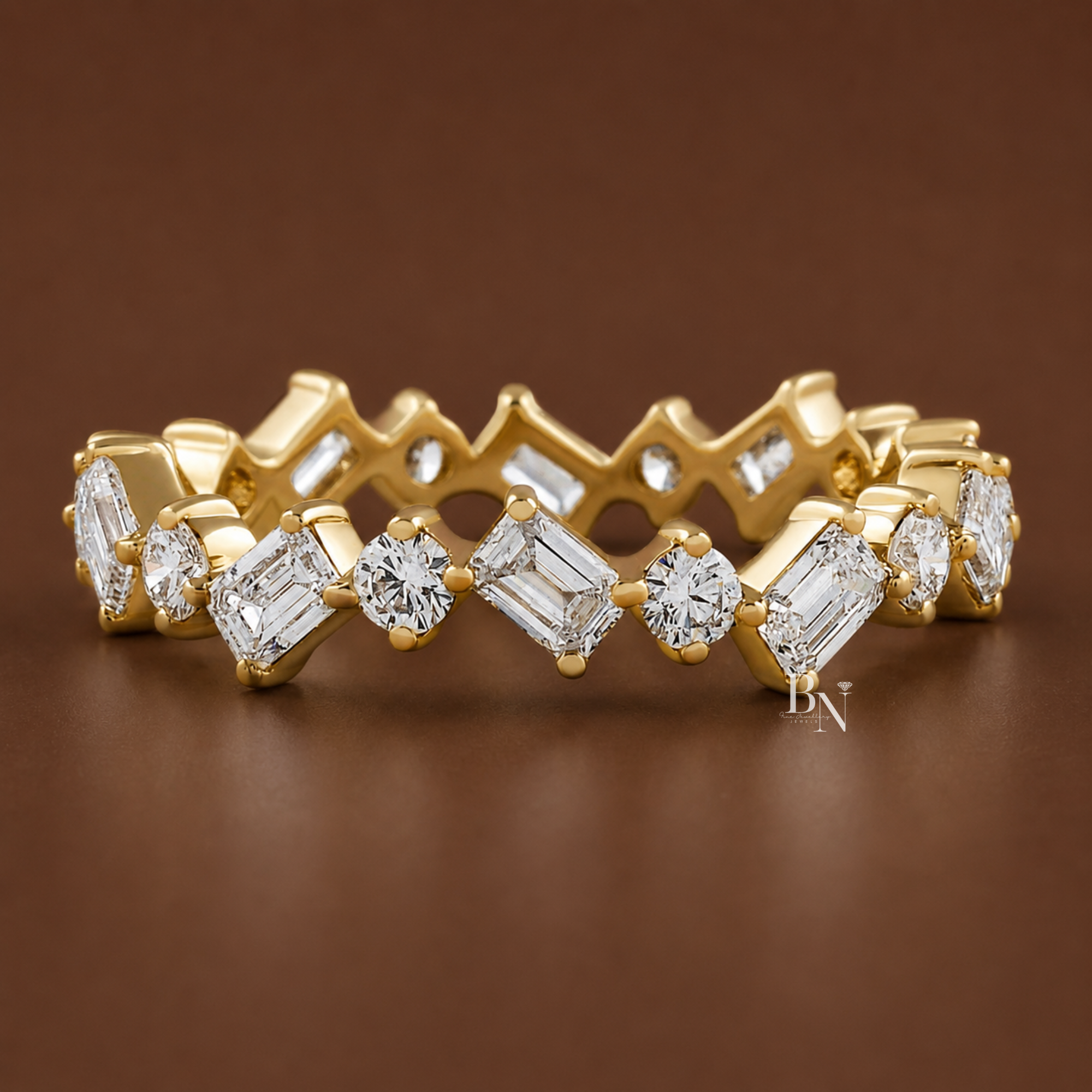 Angled view of a 14K yellow gold eternity band featuring a zig-zag pattern of alternating emerald-cut and round brilliant lab-grown diamonds.