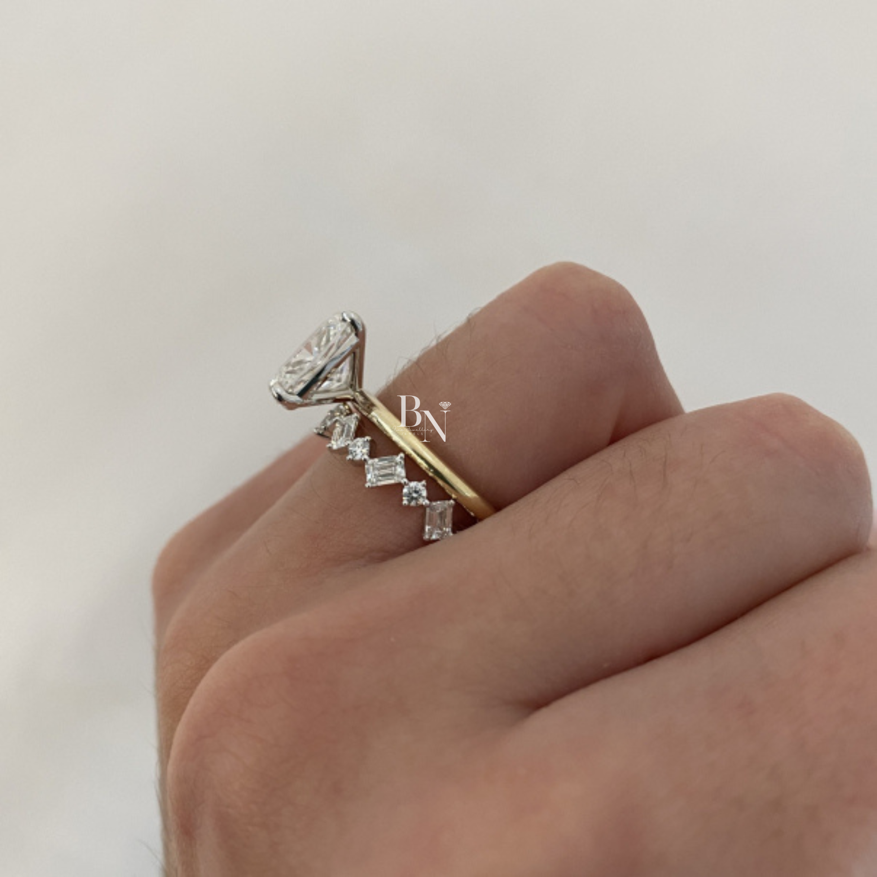 Angled view of a 14K yellow gold eternity band featuring a zig-zag pattern of alternating emerald-cut and round brilliant lab-grown diamonds.