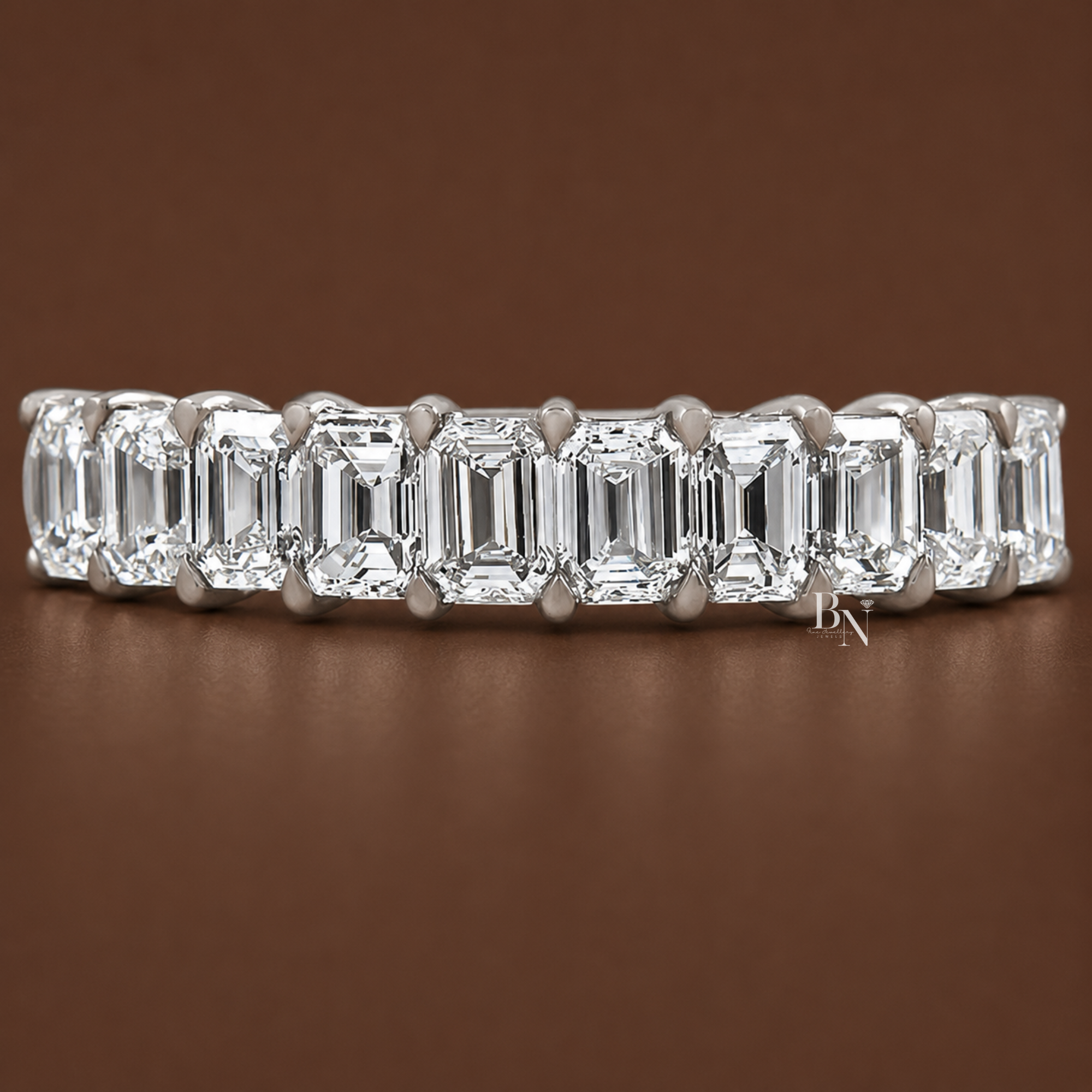 A 1.50 TCW emerald cut lab-grown diamond halfway band set in 18k gold with a shared prong wire basket setting, perfect for stacking with engagement rings.