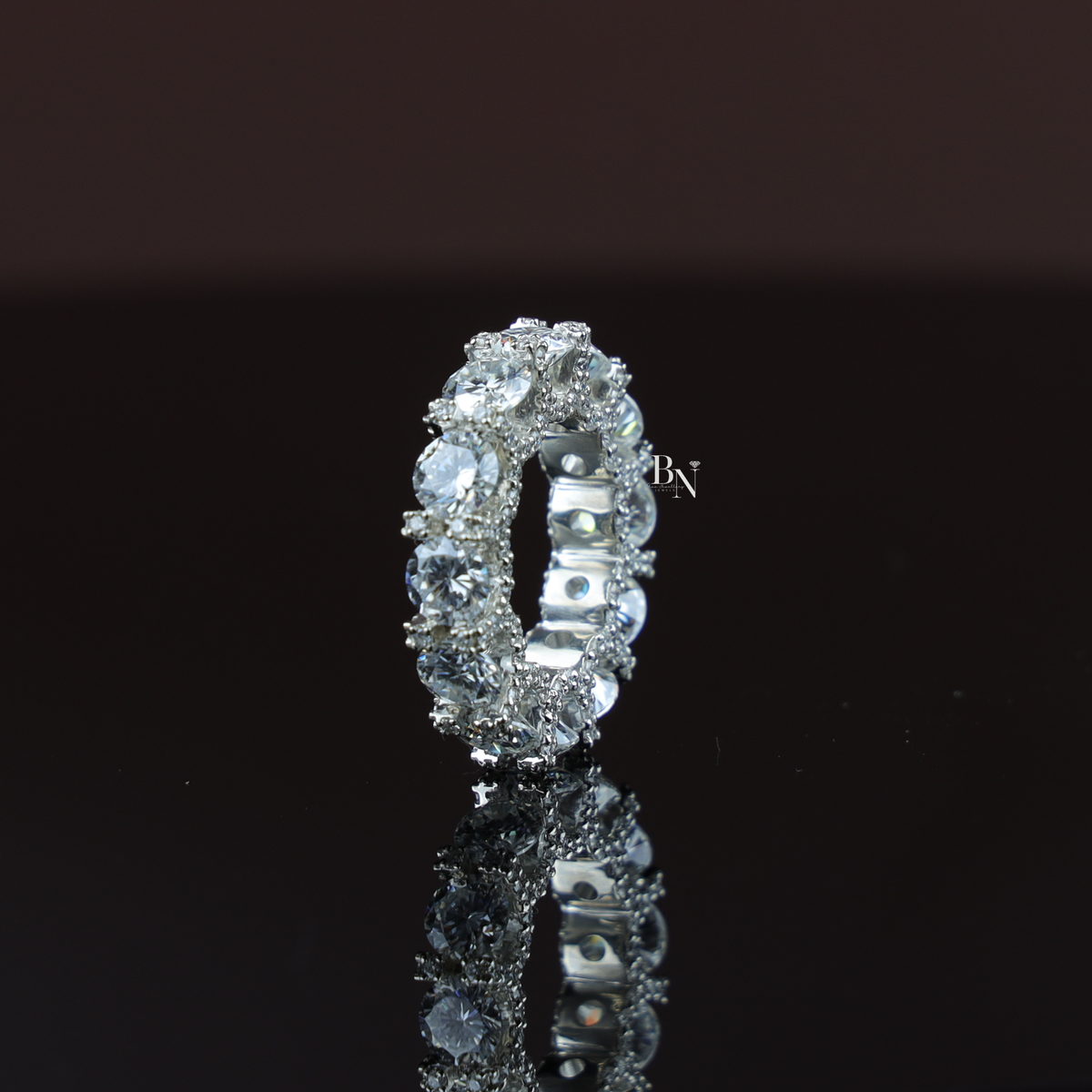 An 8.50 carat round brilliant cut lab-grown diamond full eternity ring in a shared-prong setting worn on a finger.