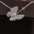 Dainty 1.00 CTW butterfly pendant necklace in 14k white gold featuring a marquise cut lab diamond center stone with brilliant pavé set lab diamonds on the wings, held in a hand to show scale and fine craftsmanship.