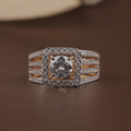 1 carat round brilliant cut lab grown diamond engagement ring with a modern square halo and unique triple row pave diamond band in 14k yellow gold, shown on a hand to highlight the wide statement band and luxury craftsmanship.