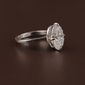 7.00 carat oval moissanite solitaire ring in 14k white gold. The stone features a crushed ice cut with intense rainbow fire and kaleidoscopic sparkle, set in a minimal six-prong high-profile mount.