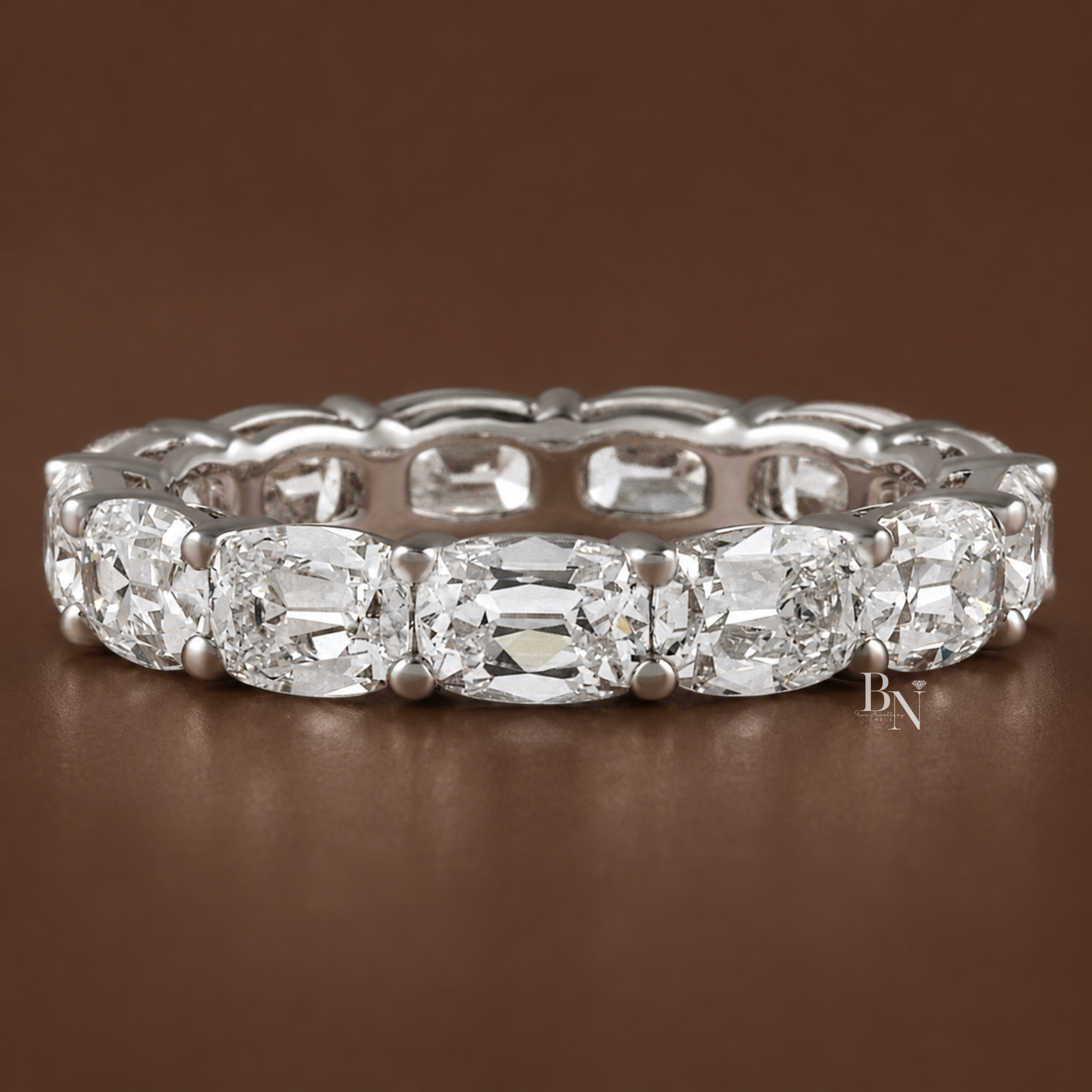 Angled view of a white gold eternity band featuring 4.10 carats of antique cushion-cut lab-grown diamonds set horizontally in an east-west shared-prong setting.