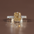 Side profile of a 3.5 carat elongated radiant cut fancy yellow lab grown diamond engagement ring featuring a sparkling hidden halo and a delicate white gold pave band with canary yellow diamond brilliance and Type IIa clarity.