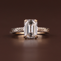 3 carat emerald cut lab grown diamond engagement ring with ornate hand-engraved vintage style band in 14k gold, fine bridal jewelry macro view.