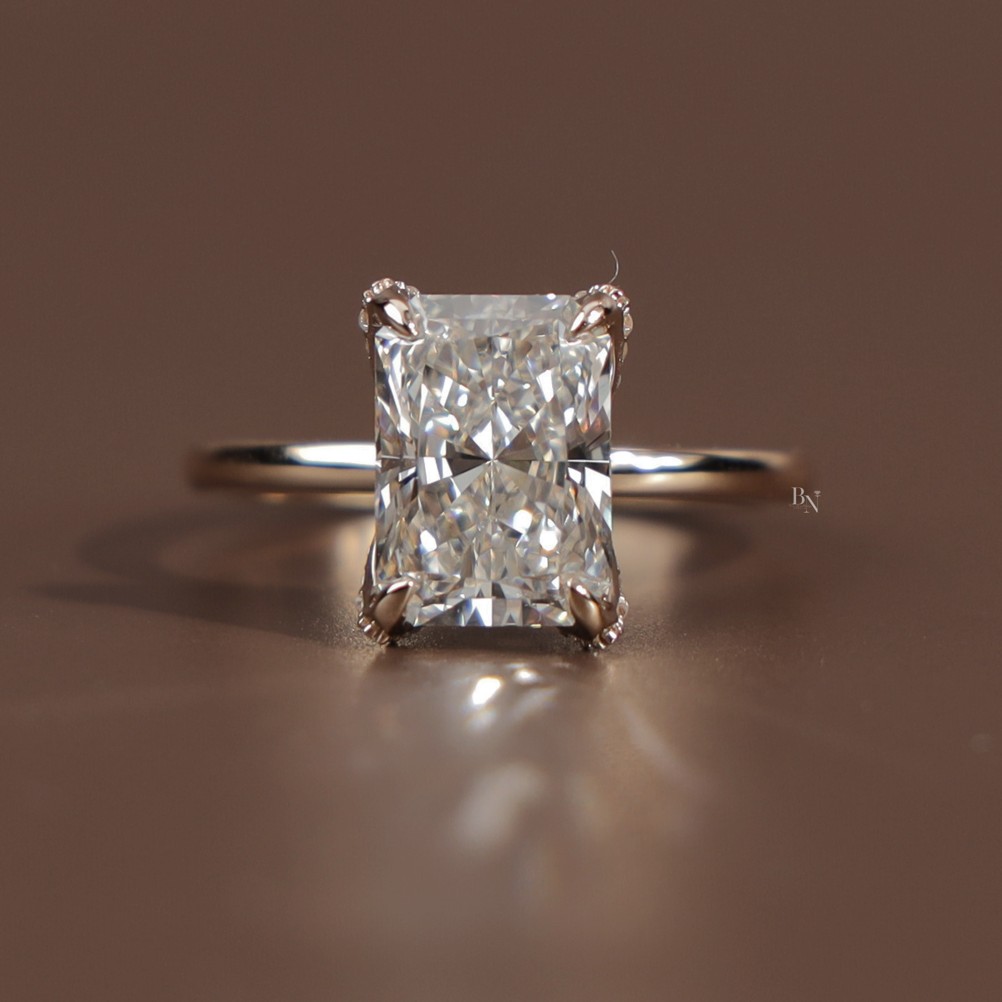 Profile view of a 3.5 carat radiant cut lab grown diamond engagement ring in 14k yellow gold featuring a sparkling hidden halo pave bridge and a delicate diamond encrusted band showcasing exceptional Type IIa clarity and icy white brilliance.
