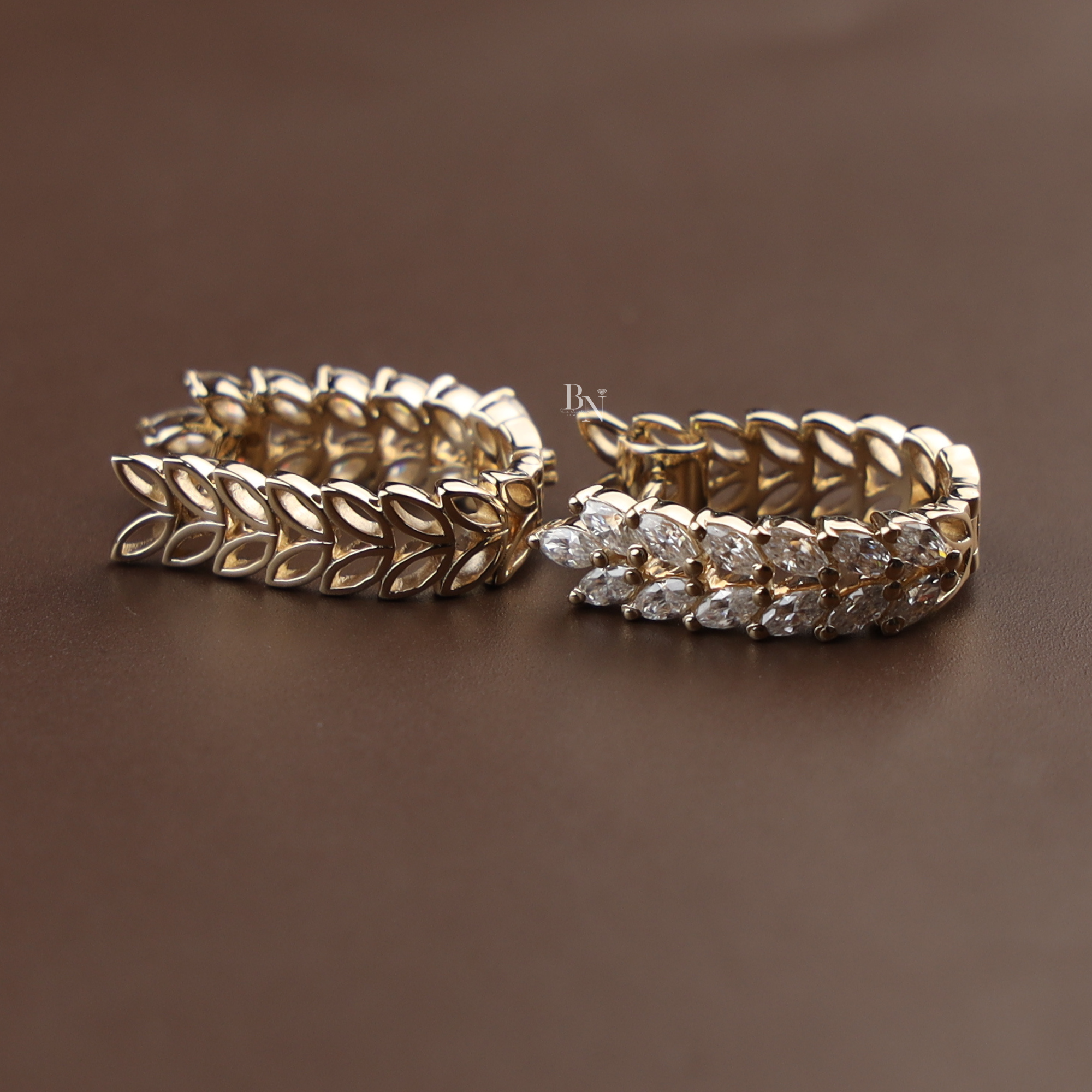 Detailed view of 0.70 carat lab grown marquise diamond huggie hoop earrings in 14k yellow gold featuring a nature-inspired double-row leaf vine pattern with sparkling brilliant white diamonds for a luxury bridal or anniversary jewelry gift.