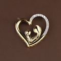 Gold heart-shaped pendant featuring a polished mother and baby silhouette design, accented with sparkling white stones on one side, shown on a delicate gold chain.