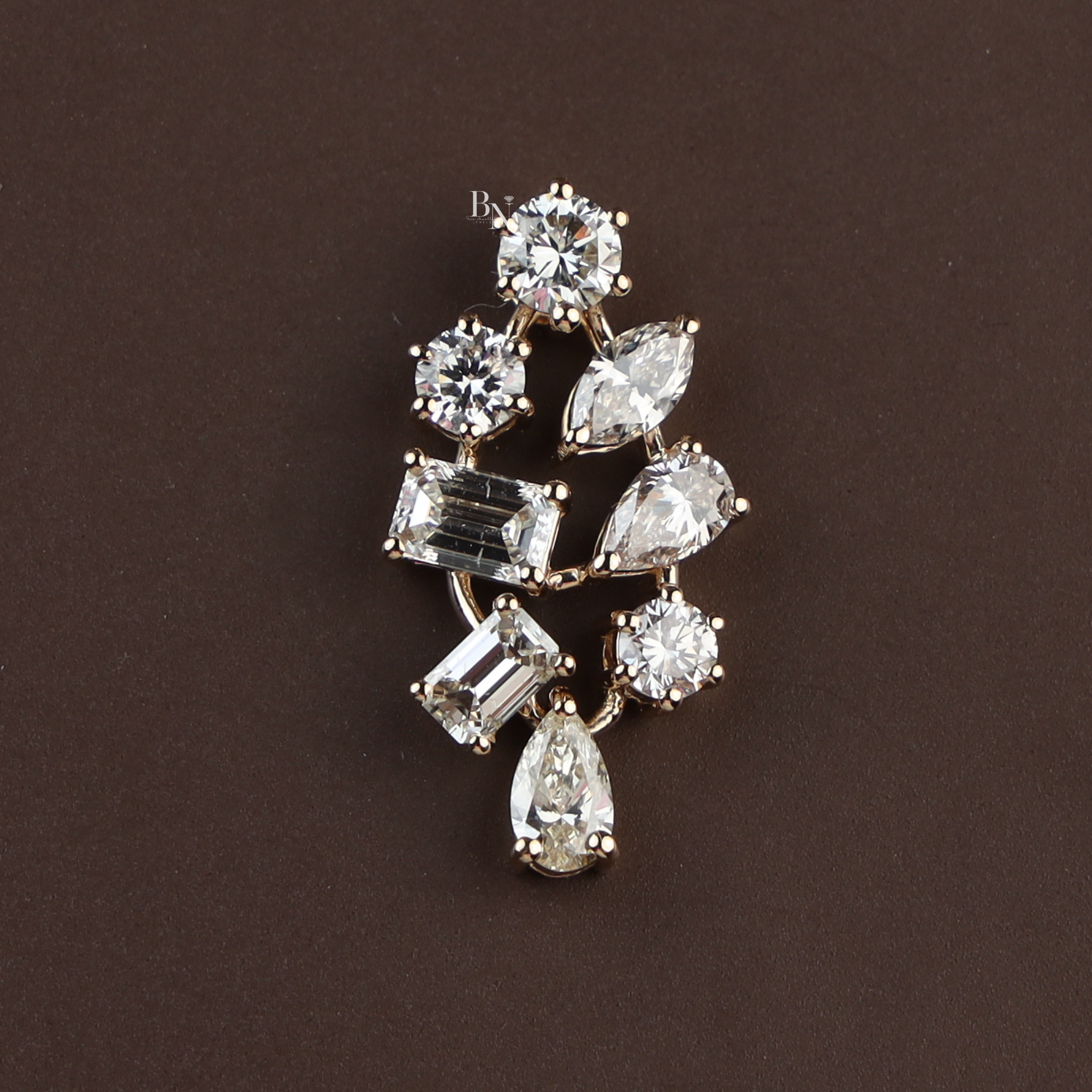 Macro view of 2.50 carat lab grown diamond mixed cut cluster pendant in 14k yellow gold featuring round brilliant, pear, emerald, and marquise diamonds on a gold chain for a high-end luxury bridal or anniversary jewelry gift.