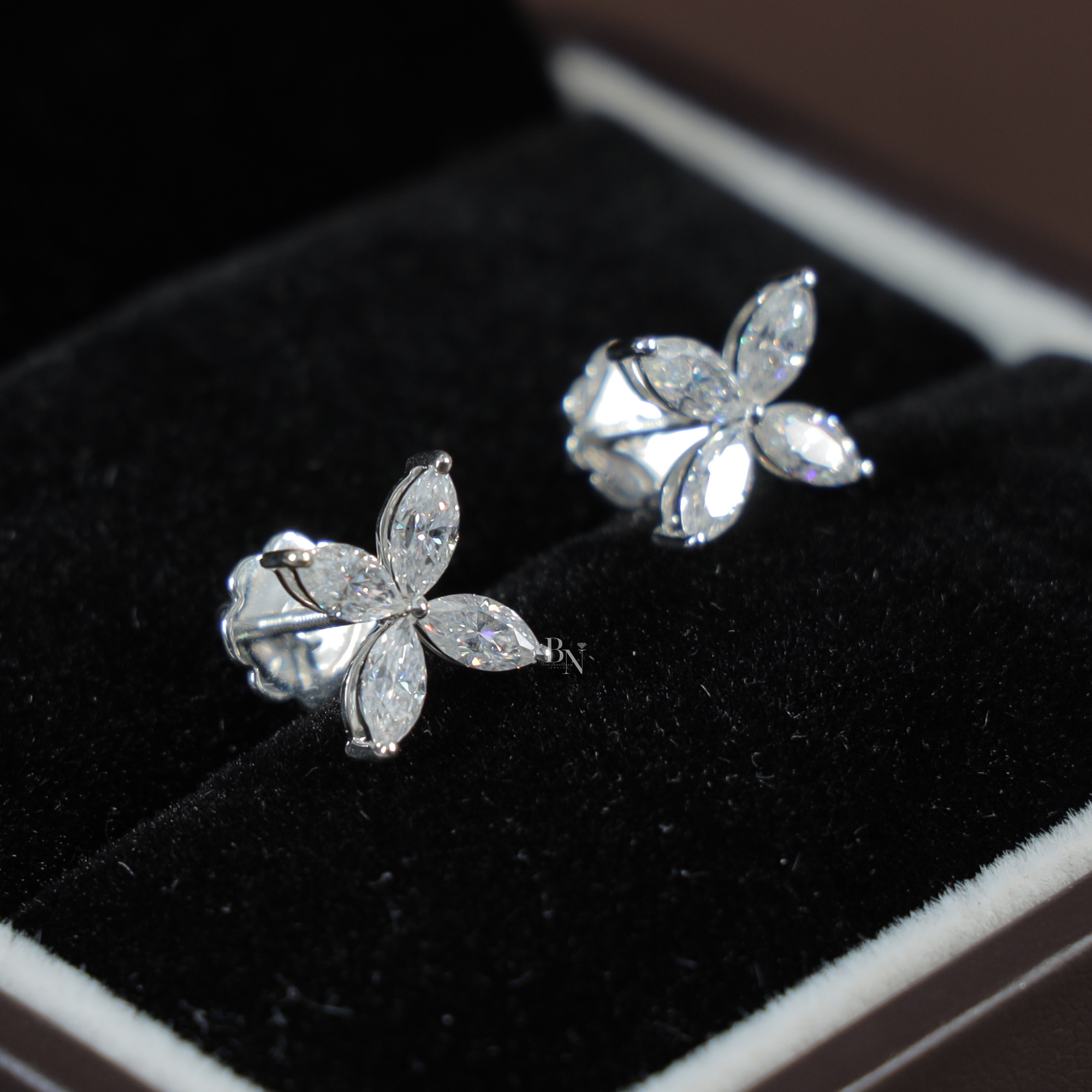 Close up of 1.60 carat marquise cut lab grown diamond floral cluster stud earrings in 14k white gold showing four marquise stones in a butterfly petal design with secure threaded screw back posts for safety and comfort.