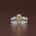 Close up view of a 1 carat fancy canary yellow radiant cut lab grown diamond engagement ring in a yellow gold full bezel setting stacked with a matching micro pave diamond chevron nesting band.