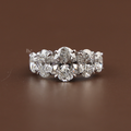 Angled view of 1.50 carat graduated five stone lab grown diamond ring in 14k white gold showing five oval cut diamonds in a shared prong setting on a polished band.