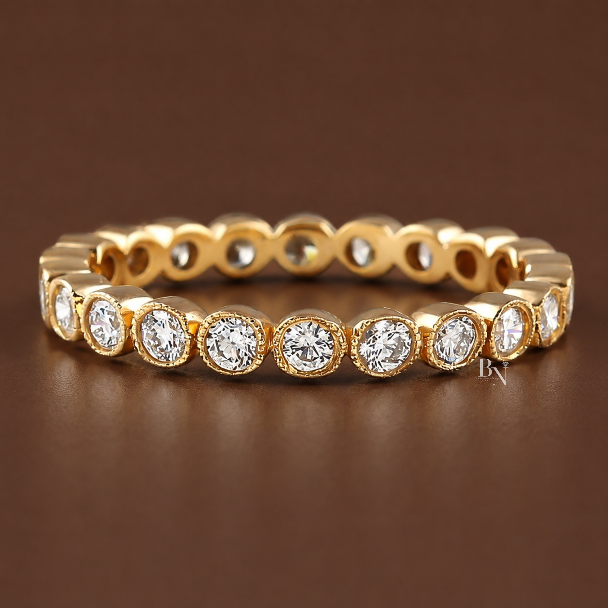 Hand modeling multiple peach and pink gemstone rings on one hand, showcasing a delicate rose gold bezel eternity band on the middle finger.