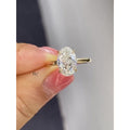 3.00 carat oval cut lab grown diamond engagement ring with a hidden halo on a classic yellow gold solitaire band.