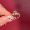 Exquisite 3.00ct elongated oval lab grown diamond engagement ring in 14k yellow gold. Features a romantic, nature-inspired vine floral accent band with marquise and round pave diamonds on the shoulders. A unique statement solitaire.