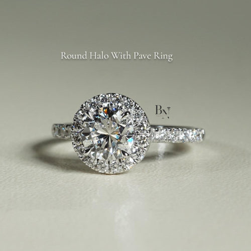 Close-up of 1 carat round brilliant cut lab grown diamond halo engagement ring in 14k white gold. Halo setting and pave band maximize stone size and crisp white light scintillation for Google Images.
