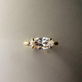 Exquisite 3.00ct horizontal marquise cut lab grown diamond engagement ring in 14k yellow gold. Features an east west setting with a dainty graduated pave accent band.